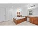 Well-lit bathroom featuring a built-in tub, vanity, tile floor, and a large mirror at 2260 Edgartown Se Ln # 1, Smyrna, GA 30080