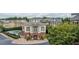 View of community pool and building with exterior columns and brick accents at 2260 Edgartown Se Ln # 1, Smyrna, GA 30080