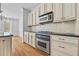 Kitchen with stainless steel oven and microwave, granite counters, and cream cabinets at 2260 Edgartown Se Ln # 1, Smyrna, GA 30080