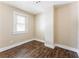 Bedroom with neutral walls, wood-look floor, and natural light from the window at 2497 Lakewood Sw Ave, Atlanta, GA 30315
