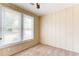Bedroom with neutral walls, carpet, wainscoting detail, and natural light at 2497 Lakewood Sw Ave, Atlanta, GA 30315