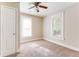 Neutral bedroom with carpet, ceiling fan, and natural light from two windows at 2497 Lakewood Sw Ave, Atlanta, GA 30315