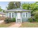 Charming cottage-style home featuring a well-manicured lawn and inviting front porch at 2497 Lakewood Sw Ave, Atlanta, GA 30315