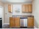 Kitchen with stainless steel appliances, wood cabinets, and sink with window at 2497 Lakewood Sw Ave, Atlanta, GA 30315