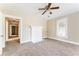 Inviting living room featuring a white fireplace, ceiling fan, and neutral carpet at 2497 Lakewood Sw Ave, Atlanta, GA 30315