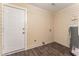 Utility room with a water heater, wood look floors and access to outside at 2497 Lakewood Sw Ave, Atlanta, GA 30315