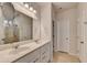 Bright bathroom with a double vanity, large mirror, and tiled shower, creating a clean and functional space at 5452 Fountainhead Ln, Auburn, GA 30011