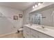 Bathroom with double sink vanity and decorative seashell artwork on the wall at 5452 Fountainhead Ln, Auburn, GA 30011