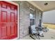 Cozy front porch featuring a red door and comfortable seating, perfect for relaxing outdoors at 5452 Fountainhead Ln, Auburn, GA 30011
