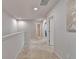 Upstairs hallway with neutral walls leads to several bedrooms and bathrooms at 5452 Fountainhead Ln, Auburn, GA 30011