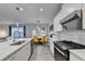 Stylish kitchen flows into a dining area, featuring white cabinets, stainless appliances, and a breakfast bar at 5452 Fountainhead Ln, Auburn, GA 30011