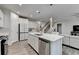 Bright, open kitchen with a central island, stainless steel appliances, and easy access to living space at 5452 Fountainhead Ln, Auburn, GA 30011