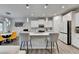 Modern kitchen with white cabinets, a large center island, stainless steel appliances, and wood floors at 5452 Fountainhead Ln, Auburn, GA 30011
