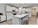 Spacious kitchen with white cabinetry, a large island with seating, and stainless steel appliances at 5452 Fountainhead Ln, Auburn, GA 30011