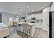 Modern kitchen with white cabinets, a large center island, stainless steel appliances, and wood floors at 5452 Fountainhead Ln, Auburn, GA 30011