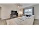Spacious living room featuring a large sectional sofa, a ceiling fan, and plenty of natural light at 5452 Fountainhead Ln, Auburn, GA 30011