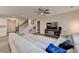 Comfortable living room area with a large sectional sofa and access to the staircase at 5452 Fountainhead Ln, Auburn, GA 30011