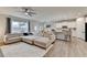 A view of the open-concept living space with a large sectional sofa, dining area, and stylish kitchen at 5452 Fountainhead Ln, Auburn, GA 30011