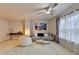 Well-lit living room with a sofa, armchair, and decorative artwork, offering a comfortable and stylish living area at 5452 Fountainhead Ln, Auburn, GA 30011