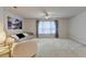 Inviting living room featuring a cozy sofa, plush chair, and large window with stylish curtains, creating a comfortable space at 5452 Fountainhead Ln, Auburn, GA 30011