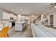 Modern kitchen and living room with stainless appliances, white cabinets, and a large sectional sofa at 5452 Fountainhead Ln, Auburn, GA 30011