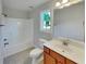 Bright bathroom features a shower-tub combination, vanity, and window for natural light at 6405 Beaver Creek Trl, Atlanta, GA 30349