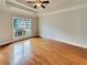 Spacious bedroom featuring hardwood floors, tray ceiling, and ample natural light at 6405 Beaver Creek Trl, Atlanta, GA 30349
