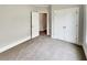 Bedroom with neutral carpet, ample closet space and view into ensuite bathroom at 6405 Beaver Creek Trl, Atlanta, GA 30349