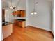 Well-lit dining area featuring hardwood floors, high ceilings and a view into the kitchen at 6405 Beaver Creek Trl, Atlanta, GA 30349