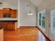 Open dining area adjacent to kitchen featuring hardwood floors, chandelier, and lots of natural light at 6405 Beaver Creek Trl, Atlanta, GA 30349