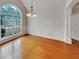 Charming dining room featuring a large window, hardwood floors, and elegant chandelier at 6405 Beaver Creek Trl, Atlanta, GA 30349