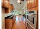 Modern kitchen featuring stainless steel appliances, granite countertops, and hardwood floors at 6405 Beaver Creek Trl, Atlanta, GA 30349