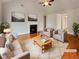 Bright, virtually staged living room with fireplace, hardwood floors, and neutral decor at 6405 Beaver Creek Trl, Atlanta, GA 30349