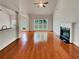 Spacious living room featuring hardwood floors, fireplace, and large window for ample natural light at 6405 Beaver Creek Trl, Atlanta, GA 30349