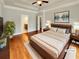 Spacious, virtually staged bedroom with tray ceiling, hardwood floors, and en-suite bathroom at 6405 Beaver Creek Trl, Atlanta, GA 30349