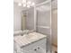 Well-lit bathroom with double shower doors, vanity with sink, and white cabinets, offering style and functionality at 9588 Poston Rd, Jonesboro, GA 30238
