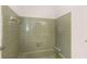 A green tiled retro bathroom features a green bathtub with silver fixtures at 9588 Poston Rd, Jonesboro, GA 30238