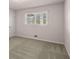 Bedroom with light gray carpet, neutral colored walls, and a window offering natural light at 9588 Poston Rd, Jonesboro, GA 30238