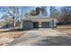 Cozy single-story home featuring a convenient covered carport and a well-maintained concrete driveway at 9588 Poston Rd, Jonesboro, GA 30238