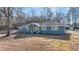 Charming single-story home features blue exterior paint, white trim, a landscaped yard and covered parking at 9588 Poston Rd, Jonesboro, GA 30238