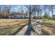Single-story home with blue exterior, white trim, and a tree-lined driveway at 9588 Poston Rd, Jonesboro, GA 30238