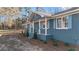 Quaint single-story home with traditional white columns, complemented by blue shutters and trimmed windows at 9588 Poston Rd, Jonesboro, GA 30238