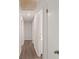 Hallway with neutral walls, vinyl plank flooring, and white doors at 9588 Poston Rd, Jonesboro, GA 30238