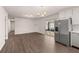 Stainless steel refrigerator in an open floor plan with access to a sunroom at 9588 Poston Rd, Jonesboro, GA 30238