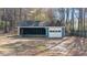 A detached garage with both enclosed and open areas, perfect for a workshop or storage at 9588 Poston Rd, Jonesboro, GA 30238