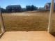 View of the backyard that displays its expansive space with newly laid sod at 98 Longhorn Way, Auburn, GA 30011