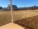 Backyard view showcasing newly laid sod with a white fence and neighboring houses at 98 Longhorn Way, Auburn, GA 30011