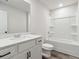 Bathroom features a white vanity, modern fixtures, and a shower-tub combo at 98 Longhorn Way, Auburn, GA 30011