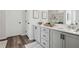 This serene bathroom features a double vanity with modern fixtures and ample storage at 98 Longhorn Way, Auburn, GA 30011