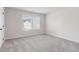 Bright bedroom featuring neutral walls, plush carpeting, and a double window for natural light at 98 Longhorn Way, Auburn, GA 30011